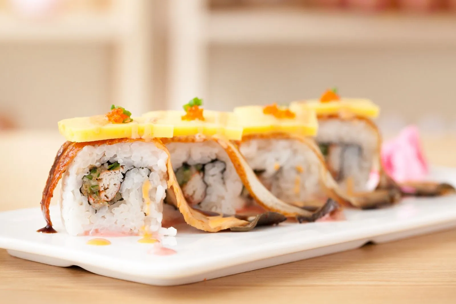 Grilled eel sushi roll with cheese and tobiko at Sushi Hut & Boba, a Japanese Restaurant in Addison