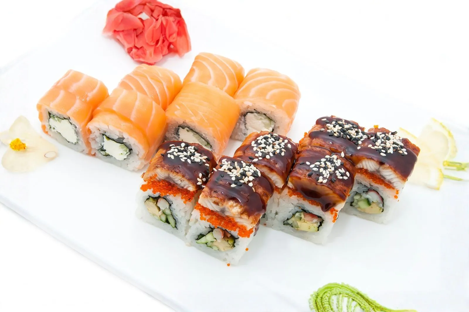 Assorted salmon and eel sushi rolls with sesame seeds at Sushi Hut & Boba, a Japanese Restaurant in Addison
